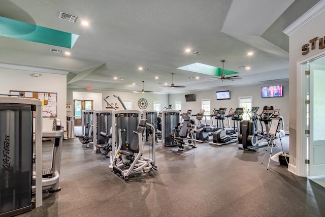 exercise room with a skylight, recessed lighting, visible vents, and ceiling fan