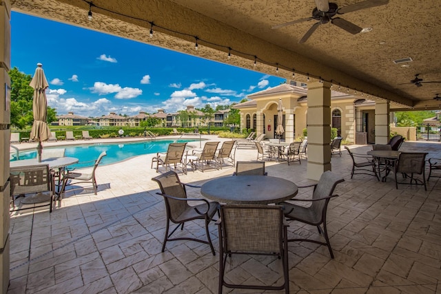 view of patio / terrace with visible vents, a community pool, and ceiling fan