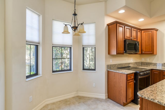 kitchen with light stone countertops, recessed lighting, an inviting chandelier, brown cabinetry, and electric range