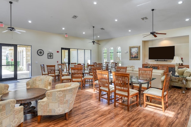 dining room with visible vents, a ceiling fan, and wood finished floors