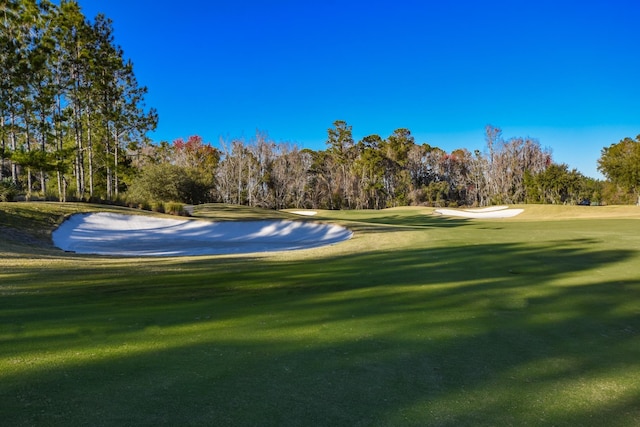 view of home's community featuring a yard and golf course view