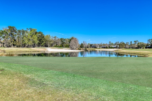 surrounding community with a yard and a water view