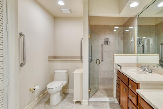 full bath with tile patterned flooring, a shower stall, toilet, recessed lighting, and vanity