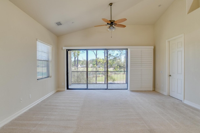 empty room featuring visible vents, light colored carpet, plenty of natural light, and a ceiling fan