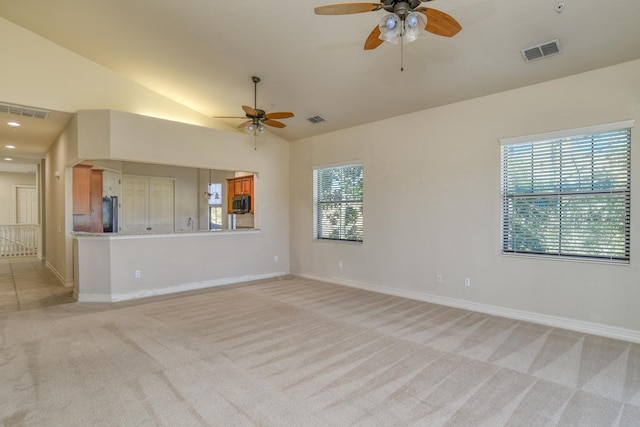 unfurnished living room with lofted ceiling, a ceiling fan, visible vents, and light carpet