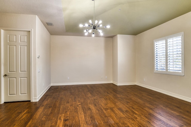 spare room featuring visible vents, baseboards, lofted ceiling, an inviting chandelier, and dark wood-style flooring