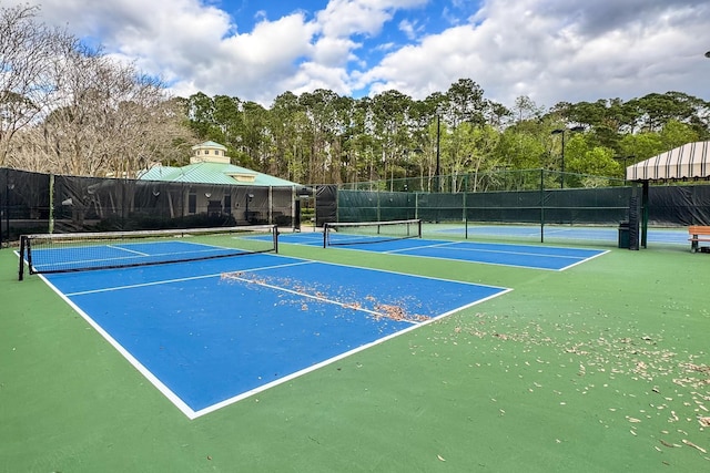 view of tennis court featuring fence