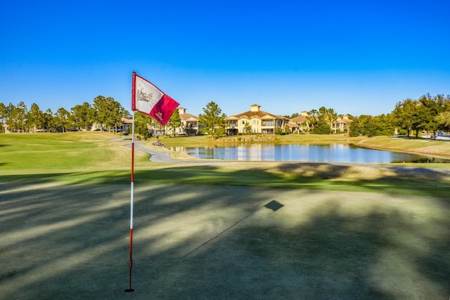 view of community with a water view and a lawn