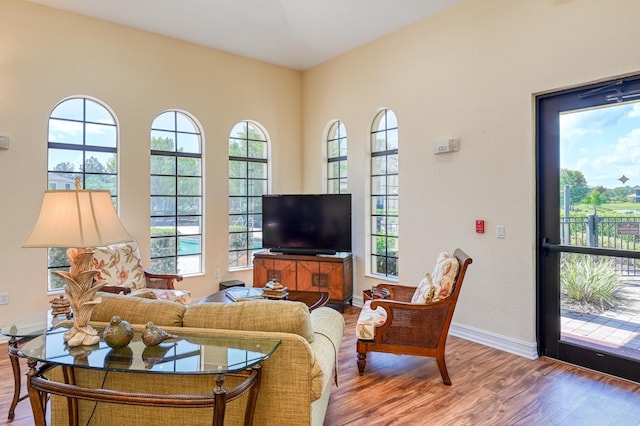 living area featuring baseboards and wood finished floors