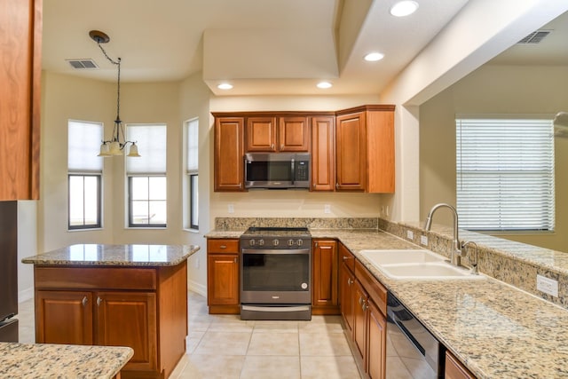 kitchen with light stone counters, visible vents, appliances with stainless steel finishes, and a sink