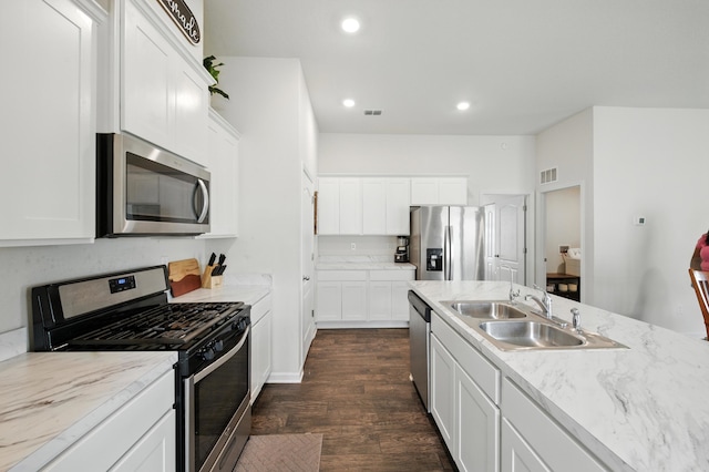313 Caminha Rd, Saint Augustine, FL 32084 - kitchen with stainless steel appliances, dark wood-type flooring, white cabinets, and recessed lighting