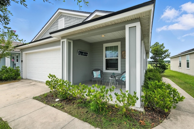 313 Caminha Rd, Saint Augustine, FL 32084 - view of front facade featuring a porch, driveway, and a garage