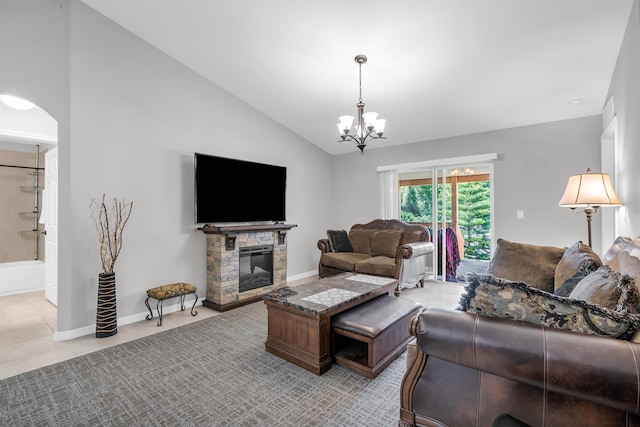 4 Contee Ct, Palm Coast, FL 32137 - living area with a chandelier, light tile patterned flooring, a stone fireplace, baseboards, and high vaulted ceiling