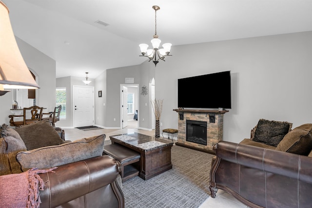 4 Contee Ct, Palm Coast, FL 32137 - living area with a chandelier, lofted ceiling, a stone fireplace, light tile patterned floors, and baseboards