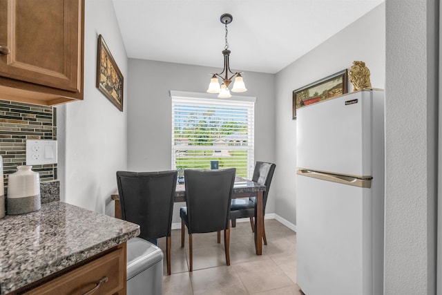 4 Contee Ct, Palm Coast, FL 32137 - dining area featuring light tile patterned floors and baseboards