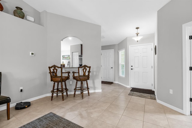 4 Contee Ct, Palm Coast, FL 32137 - entrance foyer featuring arched walkways, light tile patterned floors, and baseboards