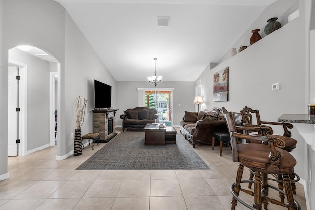 4 Contee Ct, Palm Coast, FL 32137 - living area with arched walkways, light tile patterned flooring, a chandelier, baseboards, and high vaulted ceiling