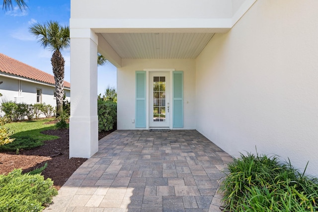 15 Cypresswood Dr, Palm Coast, FL 32137 - entrance to property featuring a patio and stucco siding