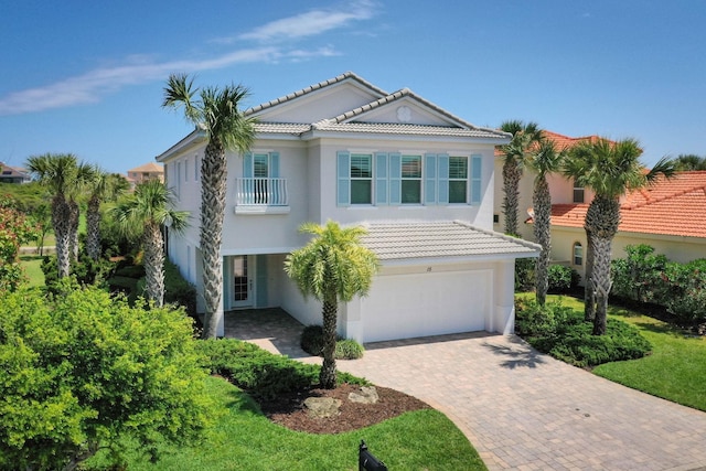 15 Cypresswood Dr, Palm Coast, FL 32137 - view of front of house featuring a garage, a tiled roof, stucco siding, and decorative driveway