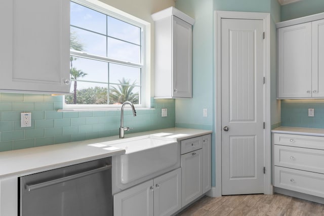 15 Cypresswood Dr, Palm Coast, FL 32137 - kitchen with light countertops, tasteful backsplash, a sink, light wood finished floors, and dishwasher