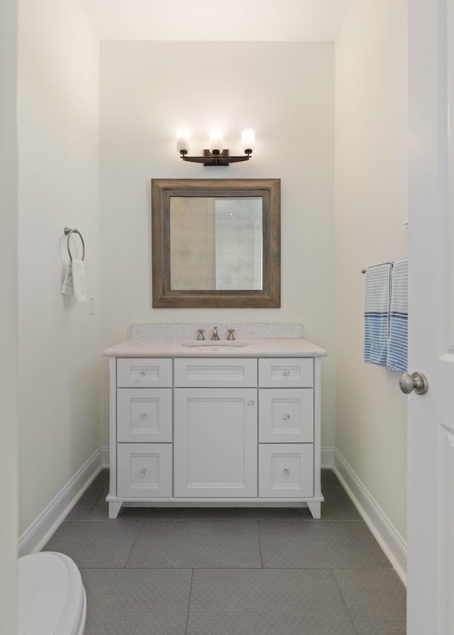 15 Cypresswood Dr, Palm Coast, FL 32137 - bathroom featuring toilet, baseboards, tile patterned floors, and vanity