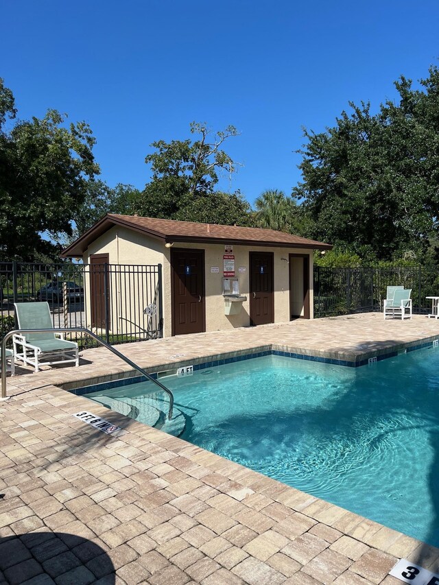 view of pool featuring a patio and an outdoor structure