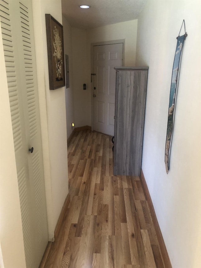 corridor featuring dark hardwood / wood-style flooring and electric panel