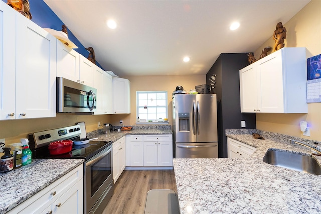 4420 Cedar Ford Blvd, Hastings, FL 32145 - kitchen with appliances with stainless steel finishes, light wood-type flooring, white cabinets, light stone countertops, and recessed lighting