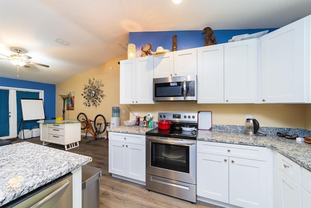 4420 Cedar Ford Blvd, Hastings, FL 32145 - kitchen with appliances with stainless steel finishes, light wood-style floors, white cabinetry, lofted ceiling, and ceiling fan