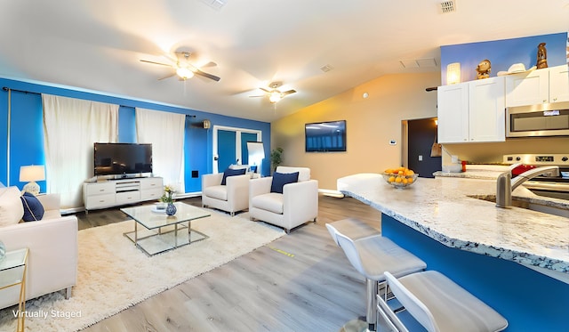 4420 Cedar Ford Blvd, Hastings, FL 32145 - living area with a ceiling fan, lofted ceiling, and light wood-type flooring