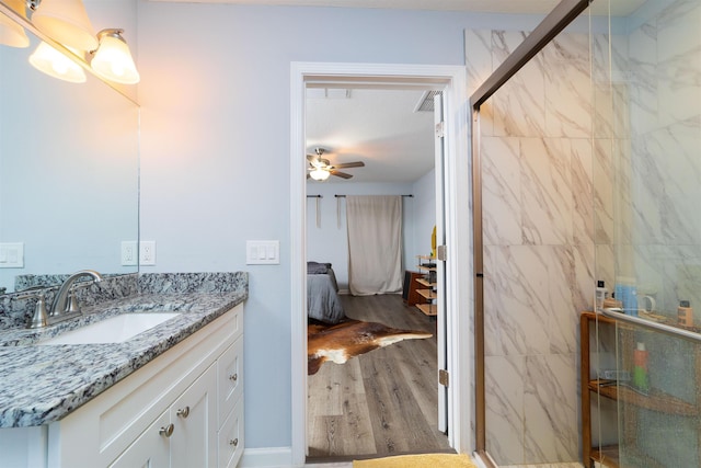 4420 Cedar Ford Blvd, Hastings, FL 32145 - full bath featuring vanity, a marble finish shower, wood finished floors, ceiling fan, and connected bathroom