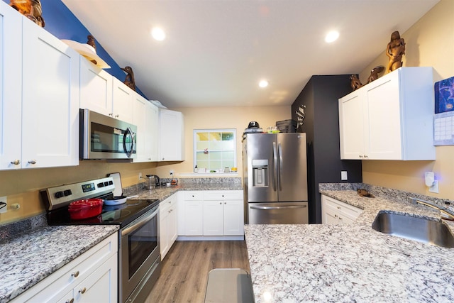 4420 Cedar Ford Blvd, Hastings, FL 32145 - kitchen featuring stainless steel appliances, light wood-type flooring, white cabinetry, and recessed lighting