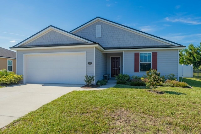 view of front of home featuring a front yard and a garage