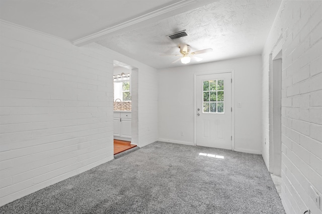 1316 NE 9th St, Gainesville, FL 32605 - unfurnished room with plenty of natural light, light carpet, a ceiling fan, and a textured ceiling