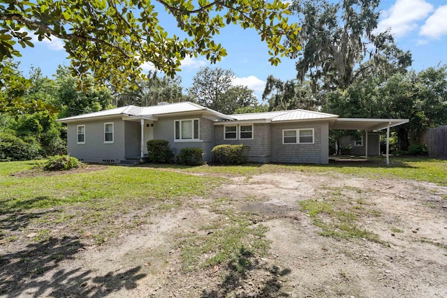 1316 NE 9th St, Gainesville, FL 32605 - ranch-style home featuring dirt driveway, a metal roof, and a carport