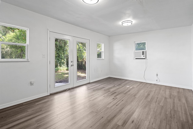 1316 NE 9th St, Gainesville, FL 32605 - unfurnished room featuring french doors, wood finished floors, and cooling unit