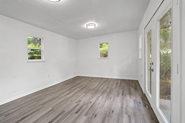 1316 NE 9th St, Gainesville, FL 32605 - spare room featuring wood finished floors and baseboards