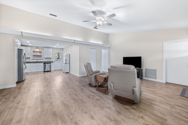 123 Bobwhite Rd, Saint Augustine, FL 32086 - living room with light wood finished floors, ceiling fan, and baseboards