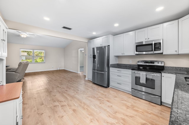 123 Bobwhite Rd, Saint Augustine, FL 32086 - kitchen with stainless steel appliances, open floor plan, light wood-style floors, lofted ceiling, and white cabinetry
