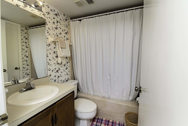 full bathroom featuring vanity, shower / tub combo with curtain, and toilet