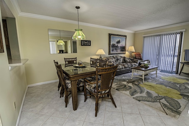 tiled dining area with ornamental molding, a textured ceiling, and plenty of natural light