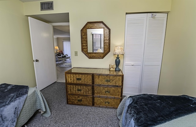 bedroom featuring dark carpet and a closet