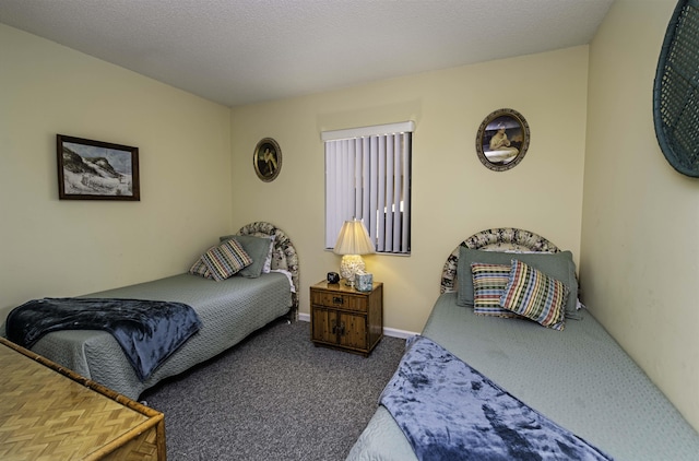 carpeted bedroom featuring a textured ceiling