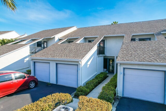 890 A1A Beach Blvd Unit 3, Saint Augustine, FL 32080 - view of front of house featuring stucco siding, a shingled roof, and asphalt driveway