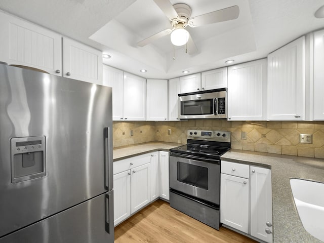 890 A1A Beach Blvd Unit 3, Saint Augustine, FL 32080 - kitchen with stainless steel appliances, ceiling fan, white cabinets, a raised ceiling, and recessed lighting