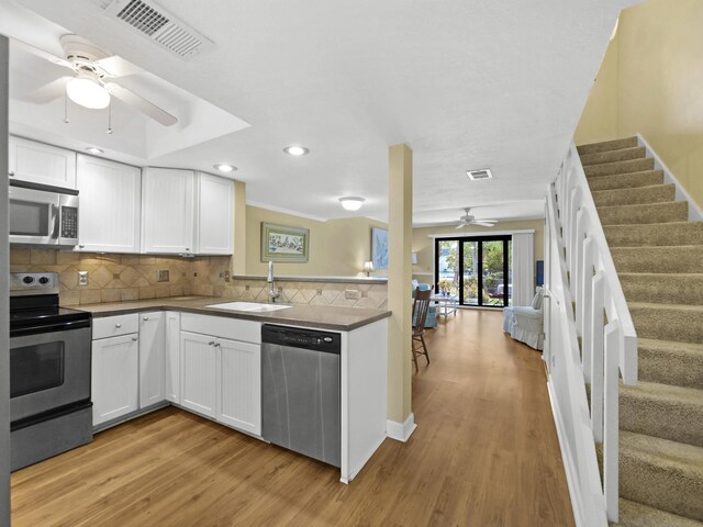 890 A1A Beach Blvd Unit 3, Saint Augustine, FL 32080 - kitchen with stainless steel appliances, a sink, a ceiling fan, light wood-type flooring, and recessed lighting