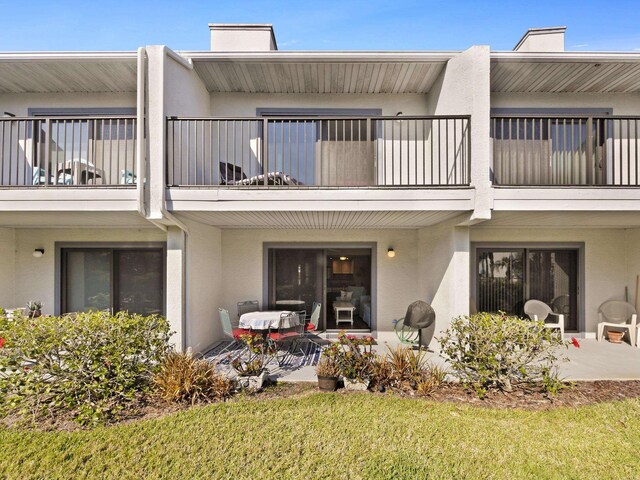 890 A1A Beach Blvd Unit 3, Saint Augustine, FL 32080 - rear view of property with a balcony, stucco siding, and a chimney