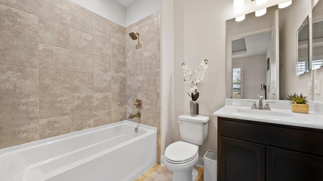 full bathroom featuring vanity, toilet, and tiled shower / bath