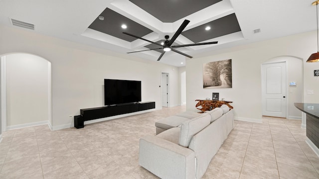 living room with ceiling fan, light tile patterned flooring, and coffered ceiling