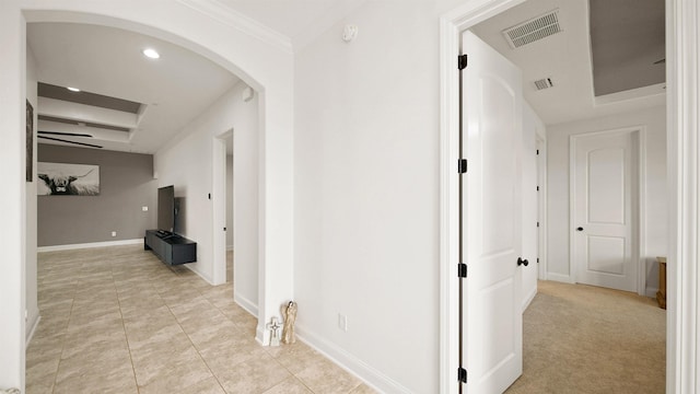 hallway featuring crown molding and light colored carpet